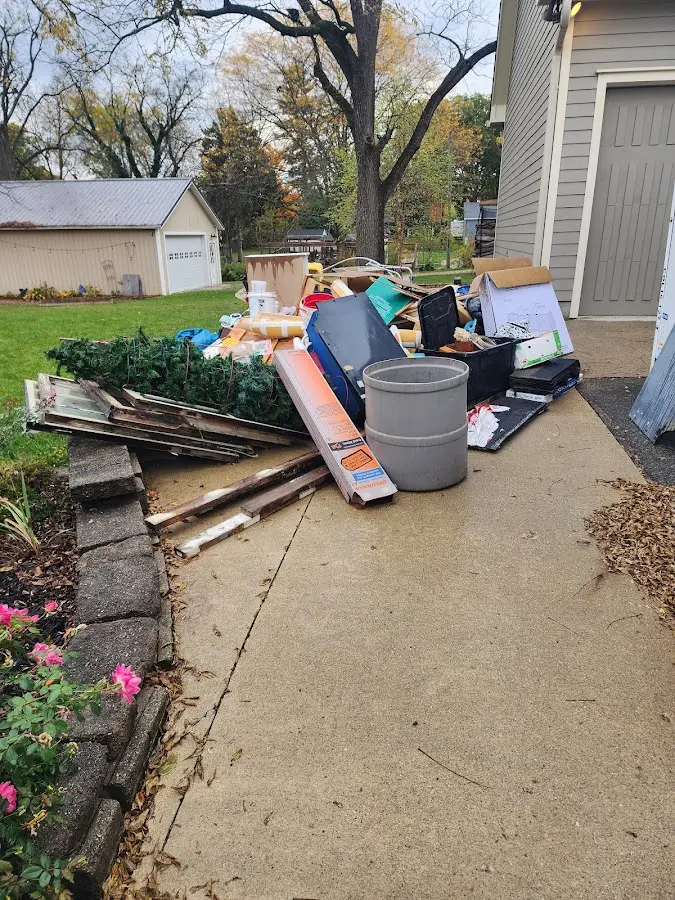 Dumpster being loaded with debris for Estate Cleanout Dumpster Rental in Northgate
